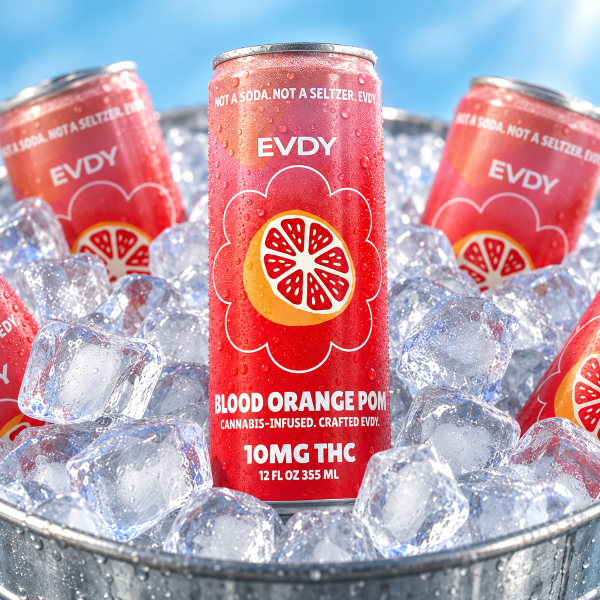 EVDY Blood Orange POM cans chilled in ice with a light blue background
